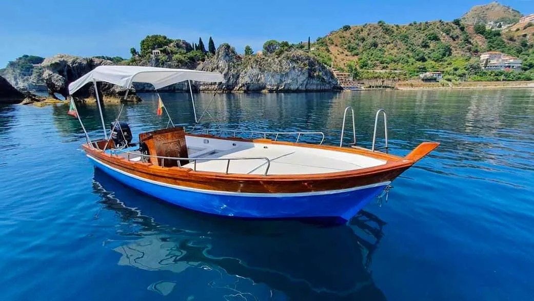Martina boat moored along the Taormina coast