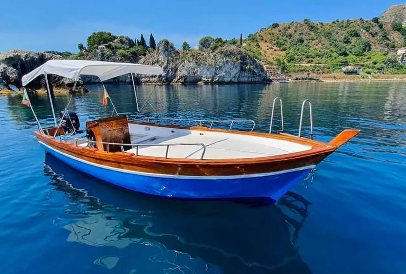Martina boat moored along the Taormina coast