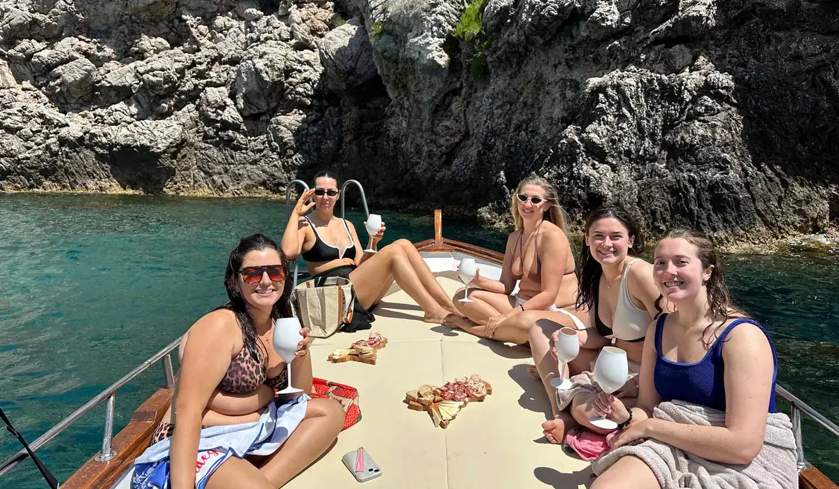 Guests toasting with Sicilian wine on the Taormina boat tour