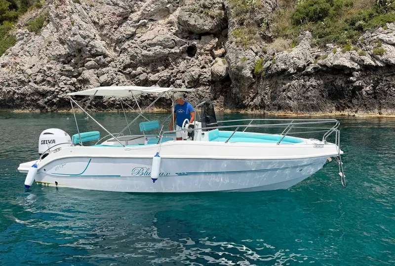 Blumax Open 23 a noleggio ormeggiata in una cala turchese vicino Taormina