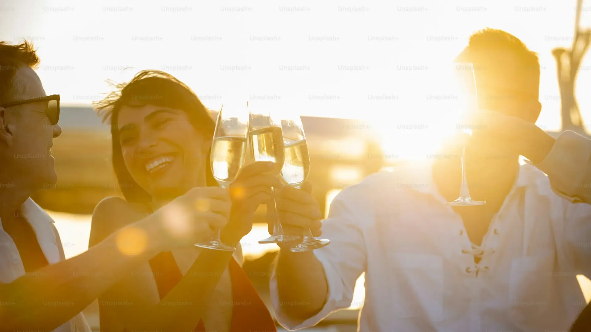 Half-day private boat tour Taormina - friends celebrating at sunset on a catamaran